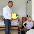 Na zdjęciu widoczny wójt, który wręcza pani Janinie bukiet kwiatów.