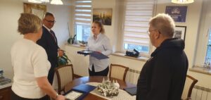 Na fotografii uchwycono moment, w którym mieszkanka wręcza wójtowi grawerton.
