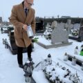 Na zdjęciu wójt składa znicz na grobie osoby zasłużonej dla gminy.